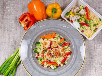 A lean pre made Food Fit meal containing mediterranean chicken in a white bowl.