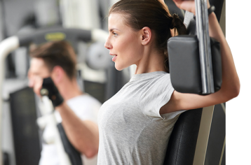 Young lady using the chest fly machine shows step 1 of the Food Fit process and how it works.