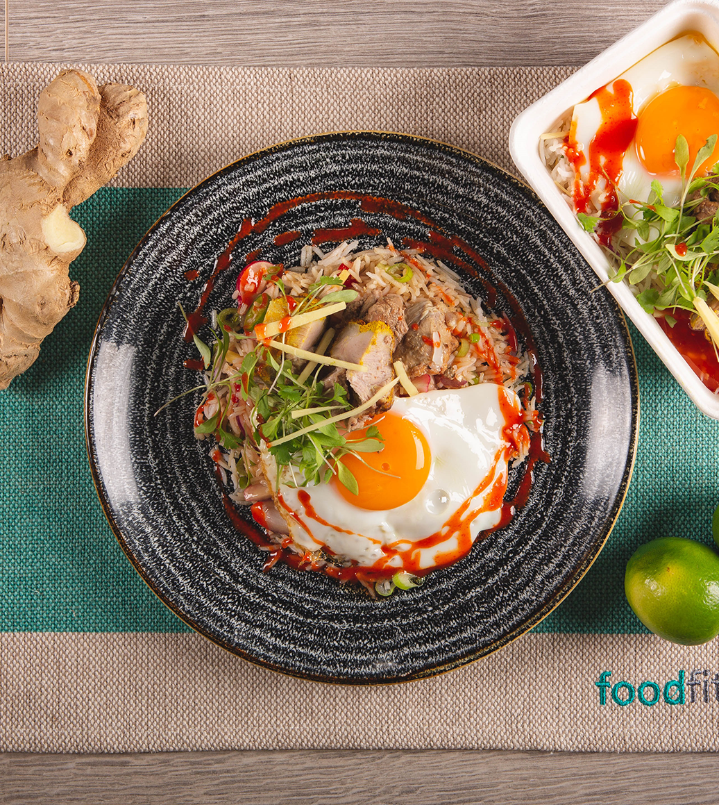 A tasty Food Fit meal on a grey plate shows Food Fits' packaging.