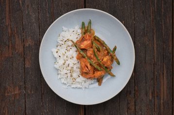 A ready cooked Food Fit meal containing kerlan pandi and rice on a light blue plate.