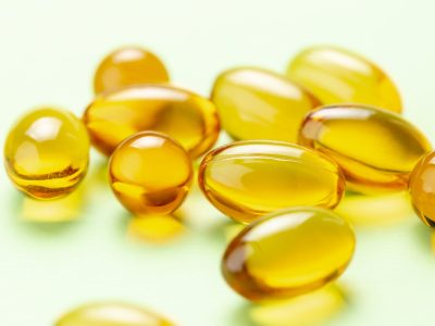 Yellow vitamin D capsules showing there's evidence they can reduce the risk of influenza and COVID-19 infections and deaths.