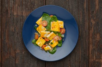 A pre-prepped Food Fit meal containing winter herb frittata on a blue plate.