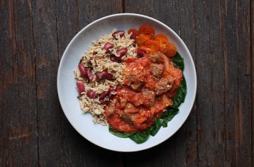 A freshly prepped Food Fit meal containing mediterranean lamb and kidney bean rice on a white plate.