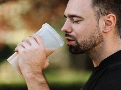 A man drinking a strawberry protein-shake